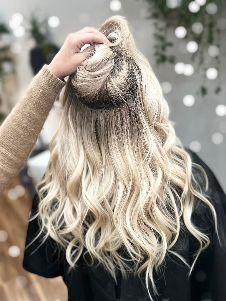 Stylist showcasing hair extensions